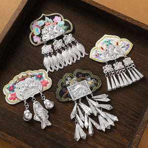 Set of four Guizhou Miao ethnic fridge magnets with embroidery and silver fringe, showcasing traditional handmade craftsmanship.