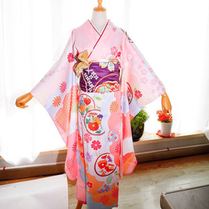 Close-up of red kimono belt with gold accents and big three-leaf bow. Geisha-style accessory with traditional Japanese patterns.