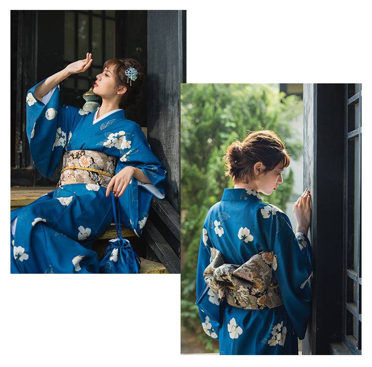 Blue floral yukata styled with a traditional brocade bow belt, showcasing the Japanese kimono waist seal in natural light.