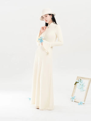 Ivory long-sleeve knit dress worn without coat