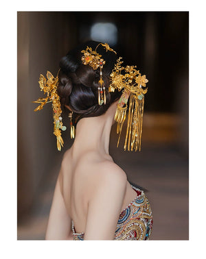 Rear view of bridal hairstyle featuring antique Chinese butterfly tassel hairpins with golden floral designs and dangling ornaments.