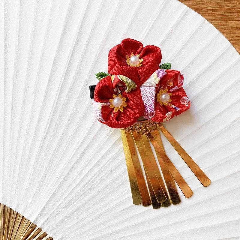 Elegant Japanese handmade crepe hairpin with red flowers and gold comb, ideal for traditional hair styling and kimono accessories.