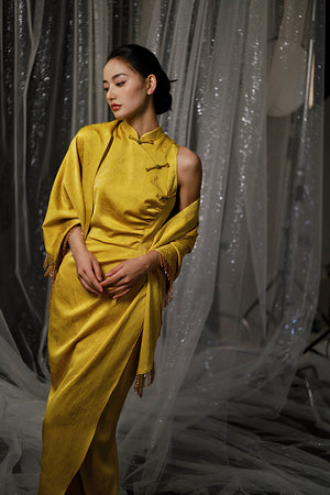 Yellow Cheongsam bridal dress with shawl in dramatic lighting, ideal for formal wedding portraits.