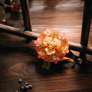 Korean hair accessories Korean traditional ethnic headgear featuring a pink floral design with pearl accents on a wooden background.