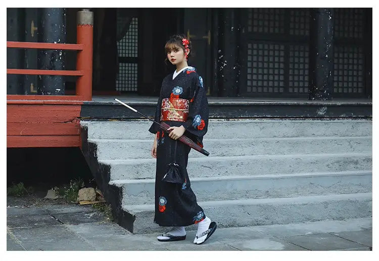 Black Japanese yukata with red and blue floral patterns, accessorized with a red umbrella. A refined choice for Halloween or formal occasions.