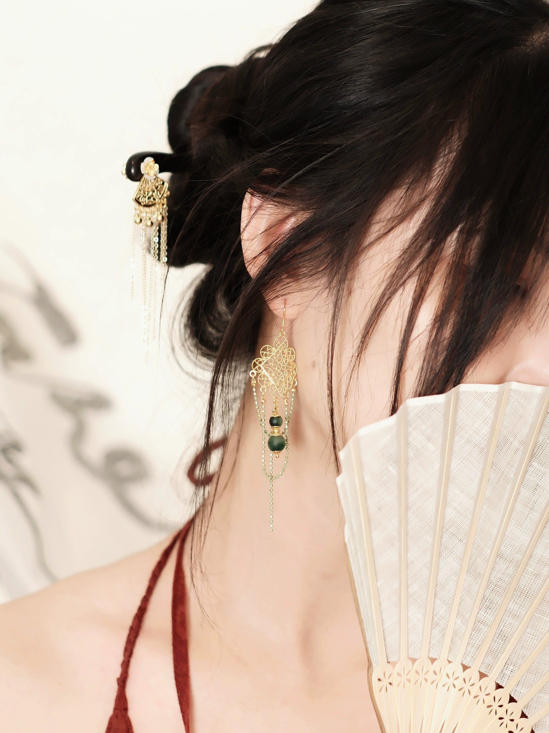 Su Mask Ear Clips - Hanfu Gold Tassel Earrings with green chalcedony, worn with traditional updo and fan for a graceful Hanfu look.