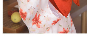 Close-up of red brocade bow belt styled with floral yukata, ideal for traditional Japanese kimono waist styling and cultural photography.