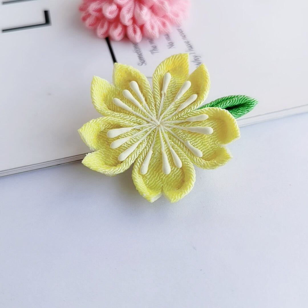 Single yellow cherry blossom hairpin with green leaf, part of the Sakura 4-piece Japanese kimono accessory set.