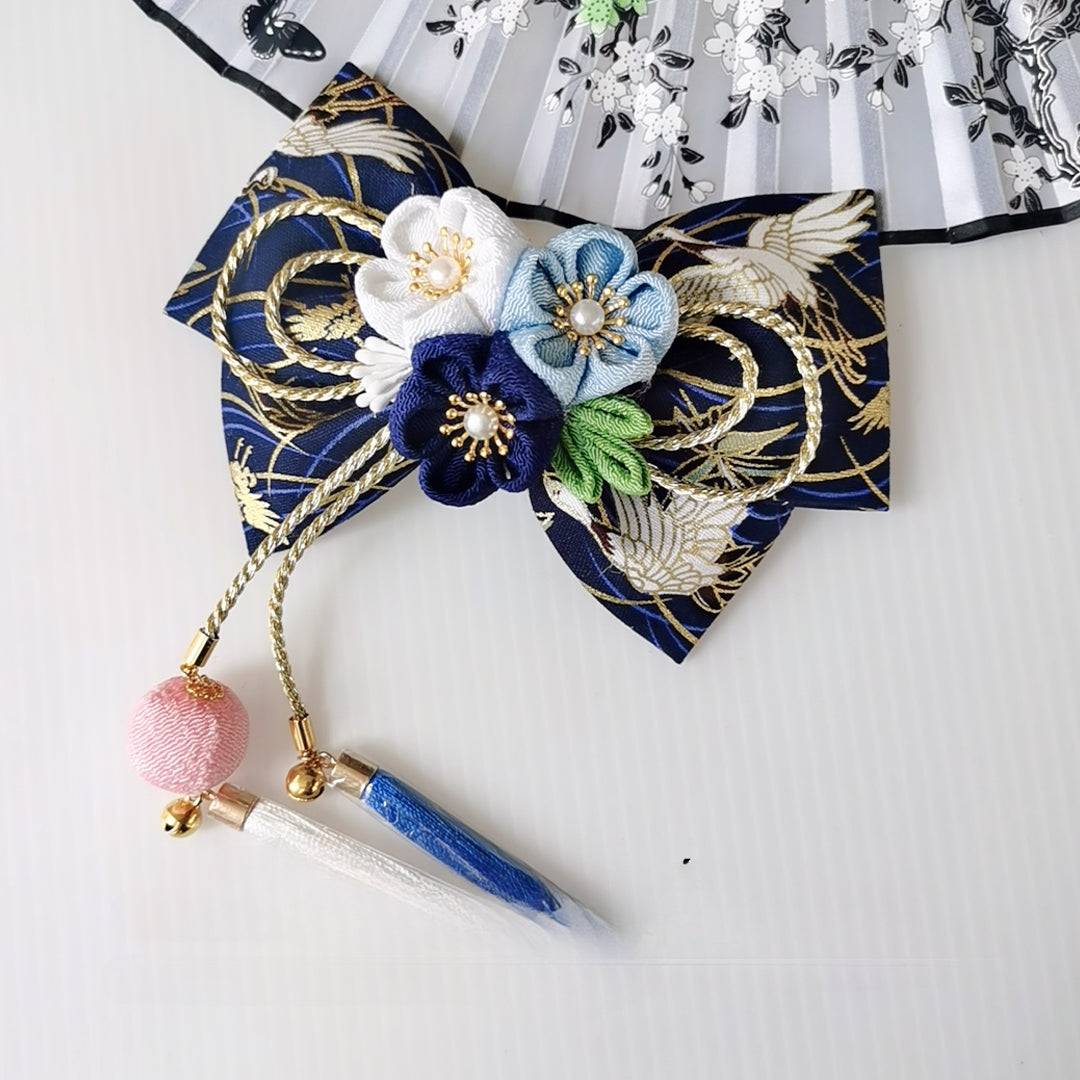 Navy blue Japanese kimono hair accessory with white and blue cherry blossoms, gold accents, and blue tassels.