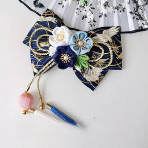 Navy blue Japanese kimono hair accessory with white and blue cherry blossoms, gold accents, and blue tassels.