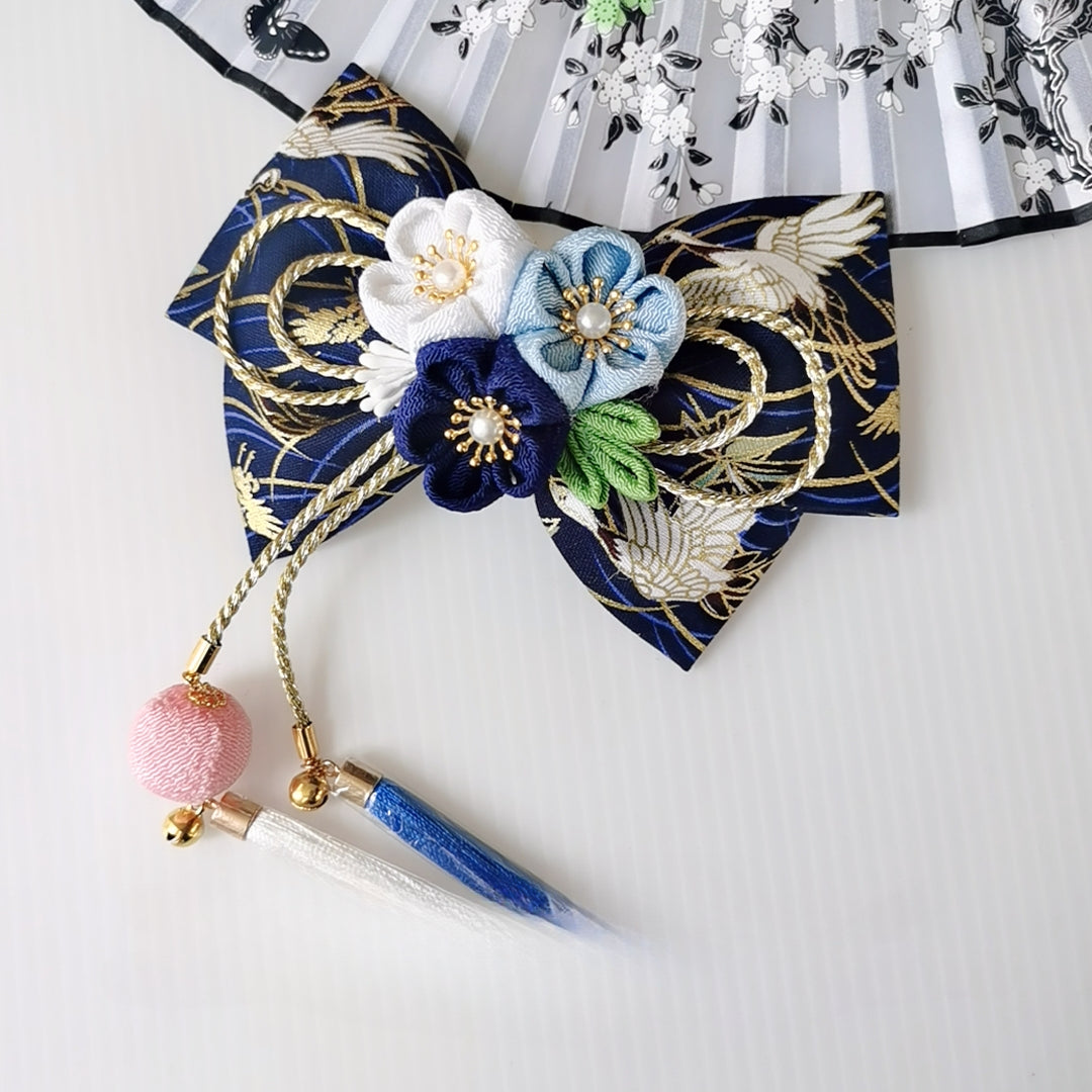 Navy blue Japanese kimono hair accessory with white and blue cherry blossoms, gold bow, and dual tassels.
