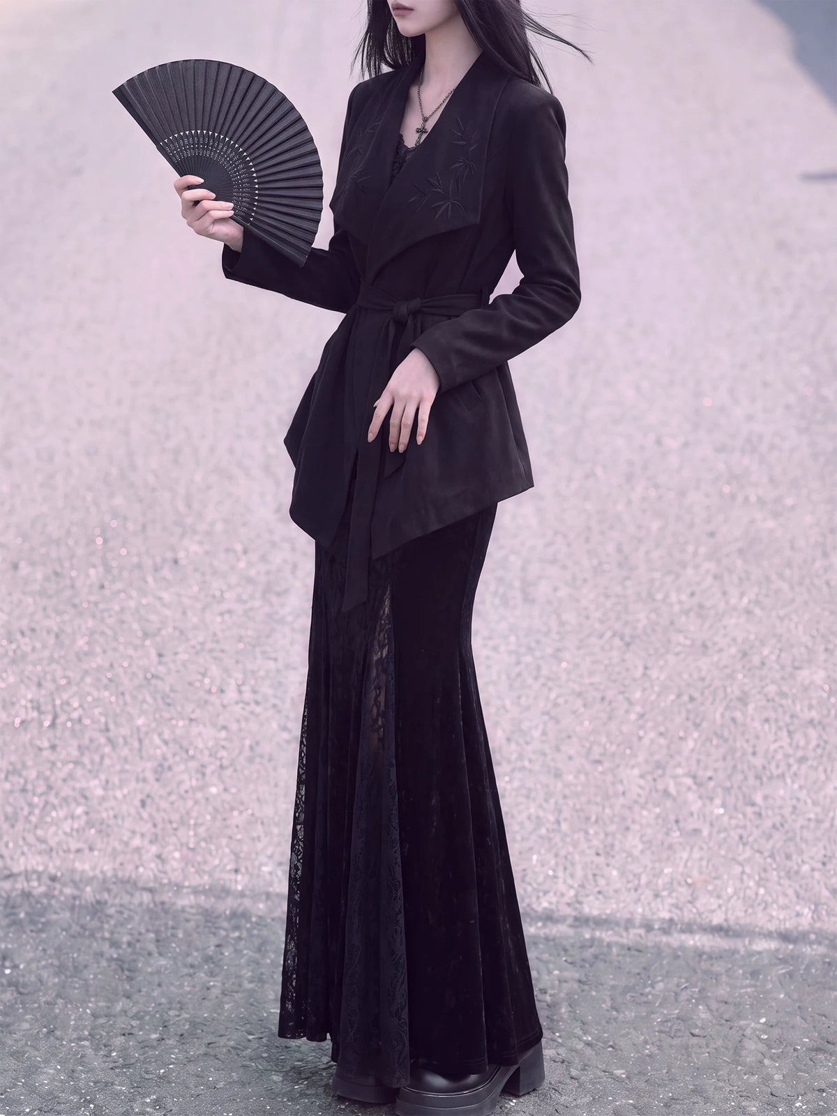 Black belted Chinese jacket styled with a folding fan