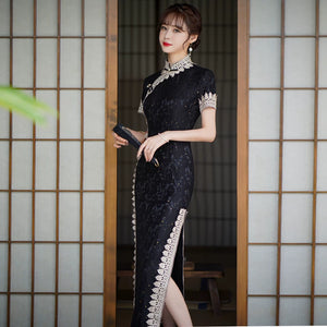 Black lace cheongsam showing the stand collar, short sleeves and scalloped contrast edging