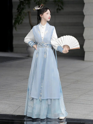 Blue hanfu dress for women, blending traditional Song Dynasty and modern Chinese styles, crafted from luxurious silk. This versatile hanfu includes options for a matching coat or jacket, making it suitable for winter wear, Chinese New Year celebrations, or casual outings. Ideal for occasions like graduations or cosplay, this dress embodies the fairy-inspired elegance of classic hanfu while also drawing from martial arts clothing and contemporary Chinese fashion. Available for purchase in our online hanfu sh