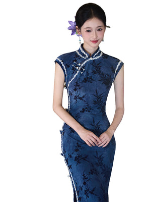Blue bamboo qipao on a white background showing the stand collar and curved front trim