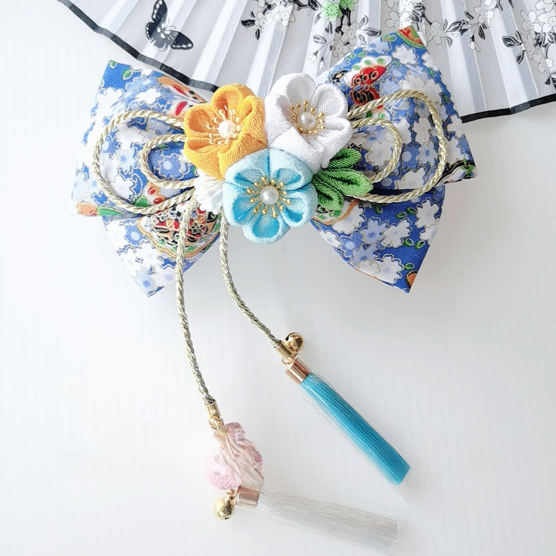 Blue floral Japanese kimono hair accessory with yellow, white, and aqua flowers, finished with tassels for a vibrant lolita look.