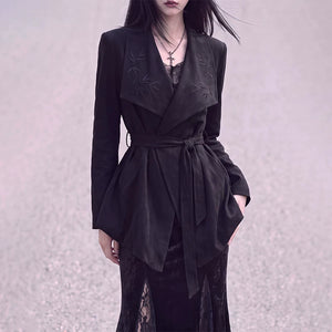 Close-up of bamboo embroidery on the black wrap jacket