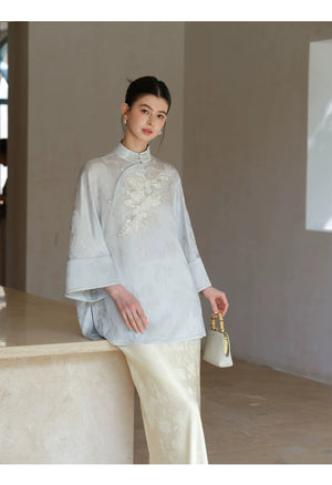 Detailed product image of the Cloud-Mist Blue embroidered satin top and skirt, showing fabric texture, finish and craftsmanship.