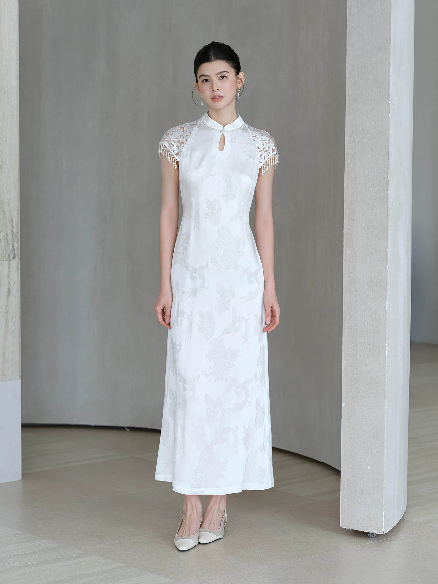 Crane White cutwork tassel qipao dress shown as a polished white qipao dress, highlighting cutwork detailing, tassel accents and a graceful modern cheongsam shape.