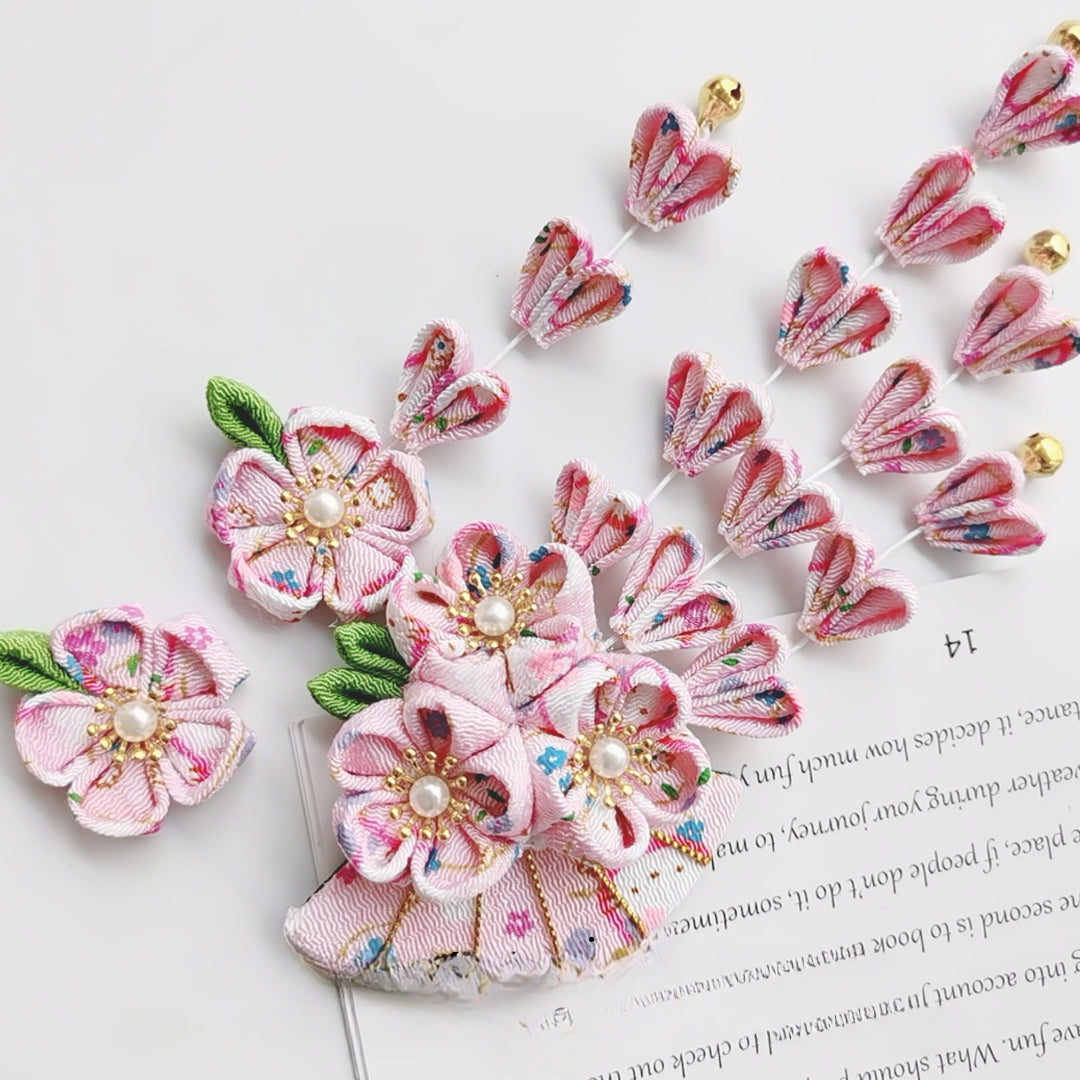 Pink floral Japanese kimono hairpin set with fan-shaped five-petal flowers and cascading tassels, perfect for festive occasions.