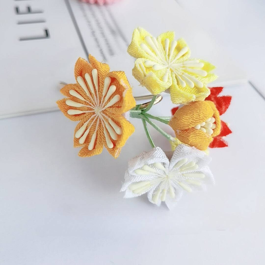 Cluster of yellow, orange, and white cherry blossom hairpins, part of the Japanese kimono accessory set.