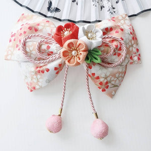 Peach and white cherry blossom kimono hair accessory with orange accents and soft pink ball tassels in lolita design.