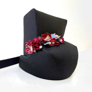 Floral decoration on a black Song-style costume hat