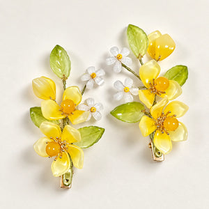 Yellow flower clips displayed as a pair