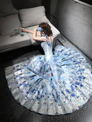 Gold-toned fish motifs on a pleated blue wrap skirt