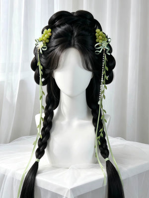 Green grape and ribbon hair clips styled beside a braided wig
