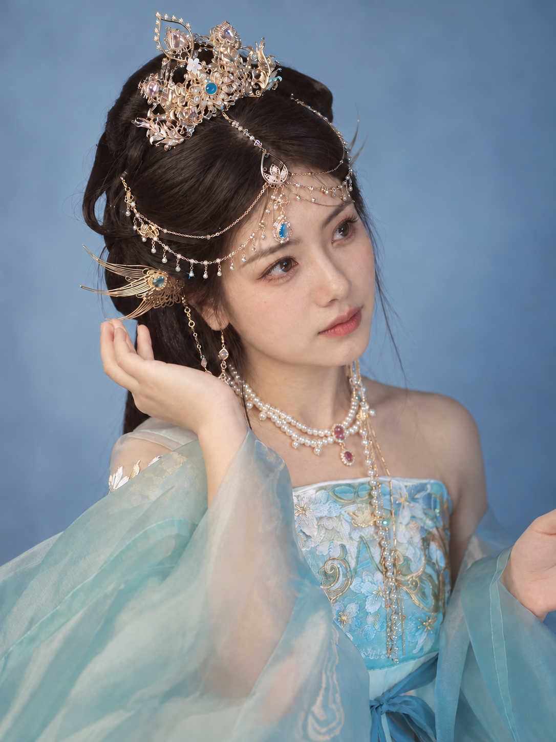 Jiaoren crown and forehead chains styled with blue clothing
