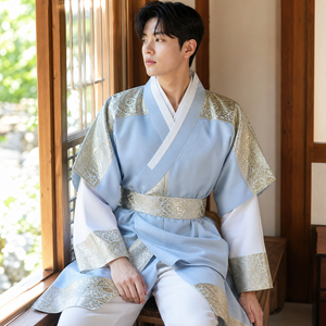 Light blue gold men's Korean hanbok robe set seated window lifestyle photo
