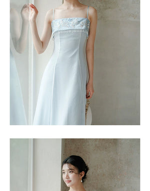 Additional styling view of the Moonlight Blue embroidered A-line slip dress, showing the garment's shape, texture and finish.