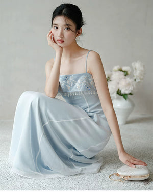 Three-quarter product view of the Moonlight Blue embroidered A-line slip dress, a refined modern Chinese dress for elegant occasions.