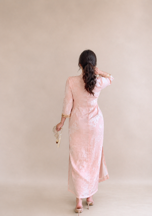 Back view of the pearl blush jacquard plus size qipao dress showing its fitted silhouette and side slit