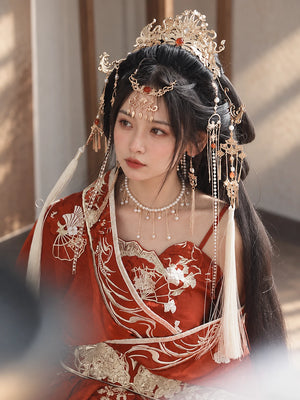 Side portrait showing phoenix crown and hanging ornaments