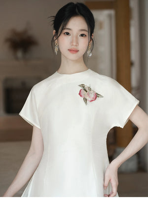 Additional styling view of the Porcelain-Moon mulberry silk top and champagne skirt, showing the garment's shape, texture and finish.