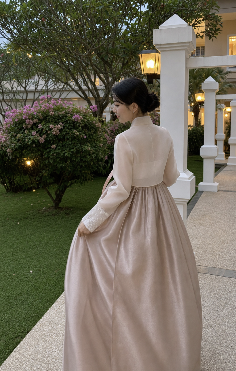 Ivory lace and champagne blush modern hanbok rental set, garden walking view