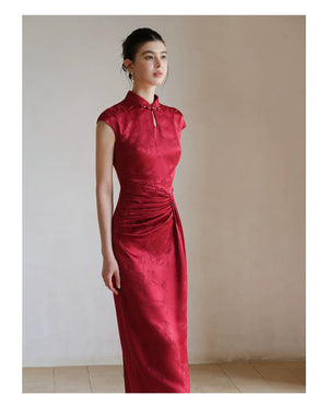Detailed product image of the Ruby Red acetate jacquard pleated qipao dress, showing fabric texture, finish and craftsmanship.