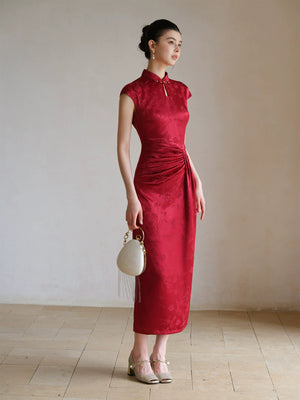 Ruby Red acetate jacquard pleated qipao dress styled to show its fit and drape, including acetate jacquard, sculpted pleats and elegant Chinese dress silhouette.