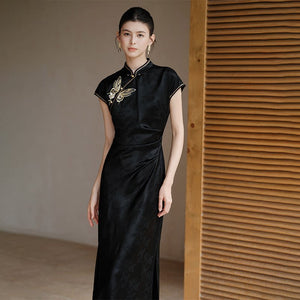 Close product view of the Smoke-Ink black acetate embroidered long qipao dress, focused on its Chinese-inspired design details.