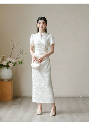 Soft White jacquard pleated qipao dress shown as a polished modern white qipao dress, highlighting subtle jacquard, fitted waist, front pleats and keyhole mandarin collar.
