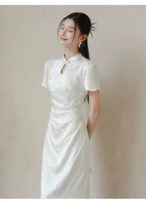 Three-quarter product view of the Soft White jacquard pleated qipao dress, a refined modern white qipao dress for elegant occasions.