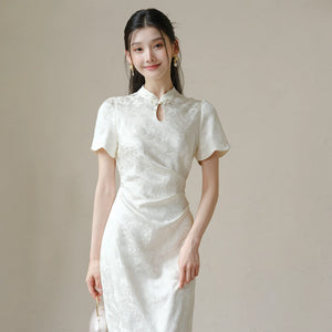 Close product view of the Soft White jacquard pleated qipao dress, focused on its Chinese-inspired design details.