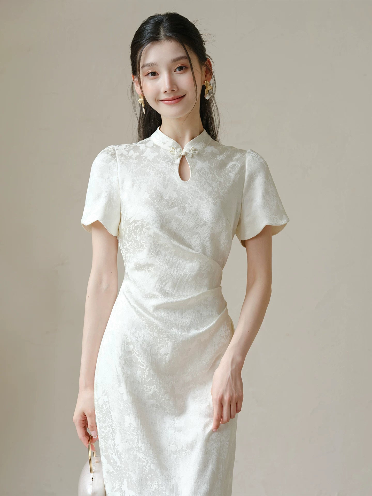 Soft White jacquard pleated qipao dress shown as a polished modern white qipao dress, highlighting subtle jacquard, fitted waist, front pleats and keyhole mandarin collar.