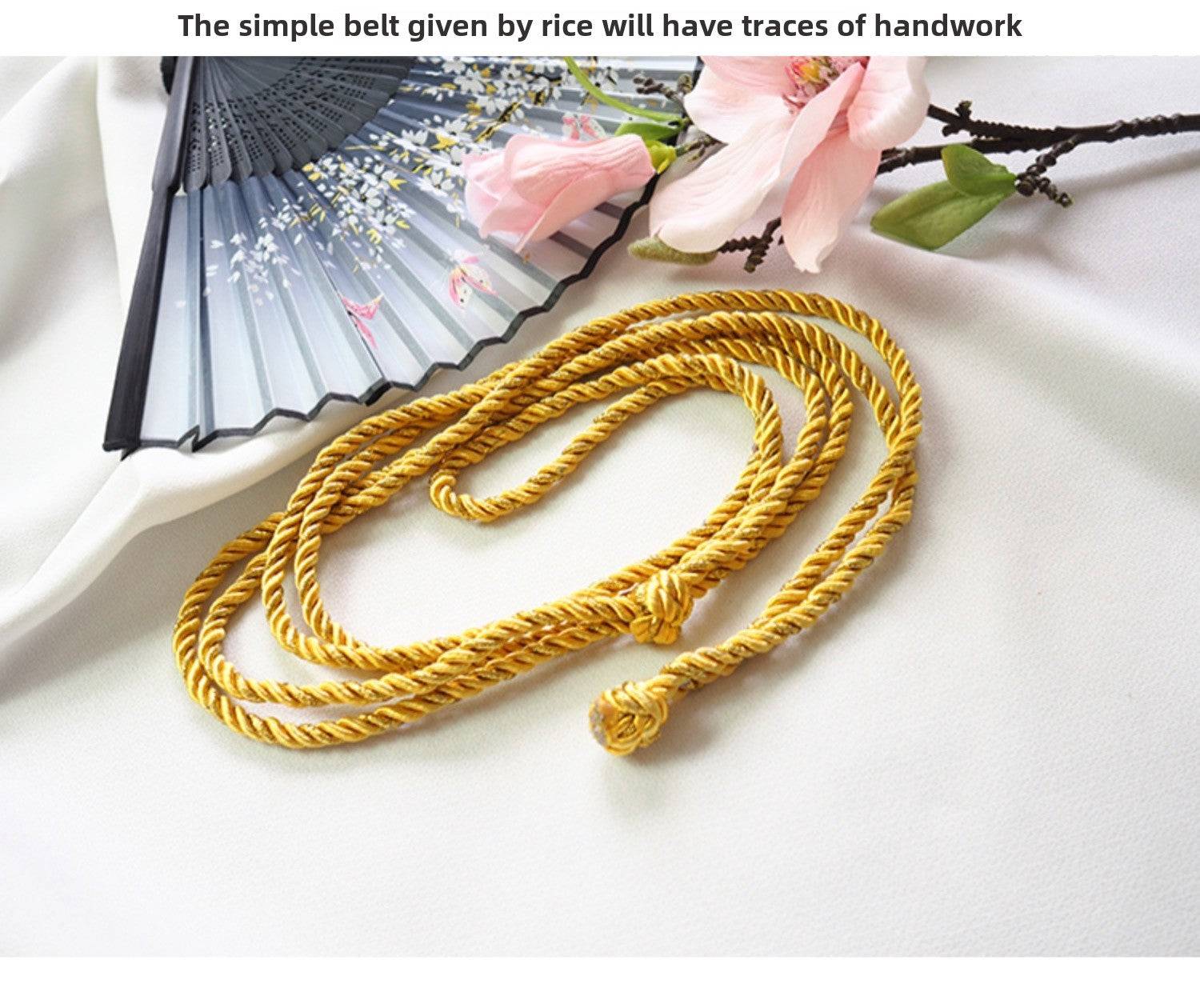 Handmade yellow rope belt accessory for Japanese kimono waist seal, paired with fan and cherry blossom decor.