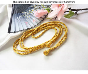 Handmade yellow rope belt accessory for Japanese kimono waist seal, paired with fan and cherry blossom decor.