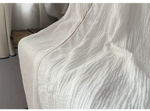 Flowing white cotton gauze hem and lightweight two-layer fabric detail