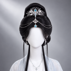 Silver-tone forehead crown with blue teardrop accent styled on an updo
