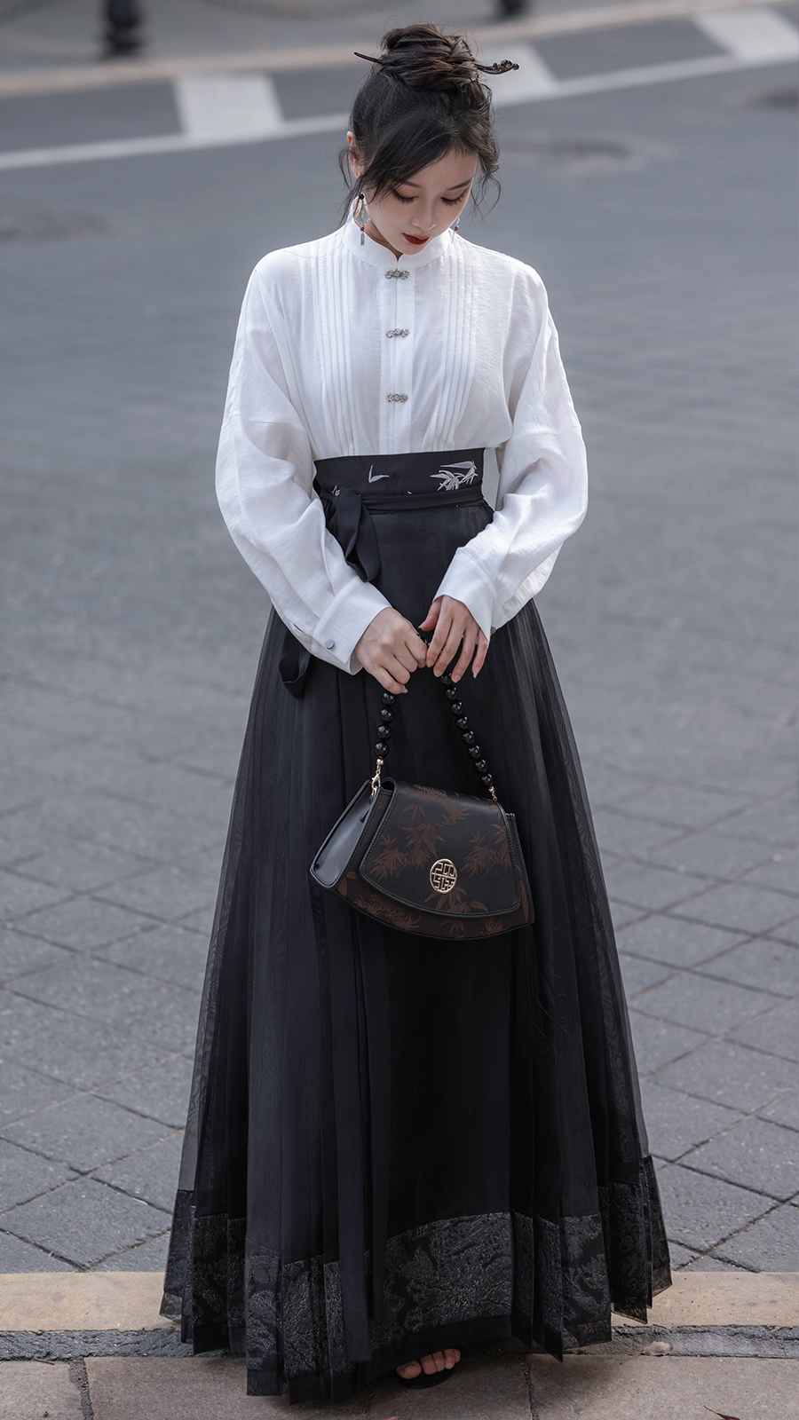 Black Mamian Featuring a diverse collection of Hanfu styles, this display presents a blend of traditional and modern elements, from the intricate embroidery of classic Hanfu to contemporary menswear. The assortment includes authentic Tang Dynasty dresses and detailed Ming Dynasty Hanfu, alongside luxurious royal attire and scholar officials' outfits. With a special emphasis on men's Hanfu, the exhibit highlights the rich cultural tapestry of traditional Asian clothing and modern, Asian-inspired fashion